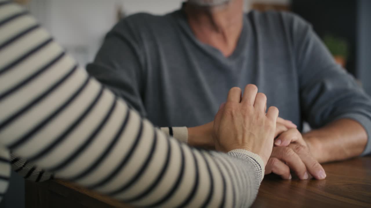 Part of caucasian woman's hands support his father.