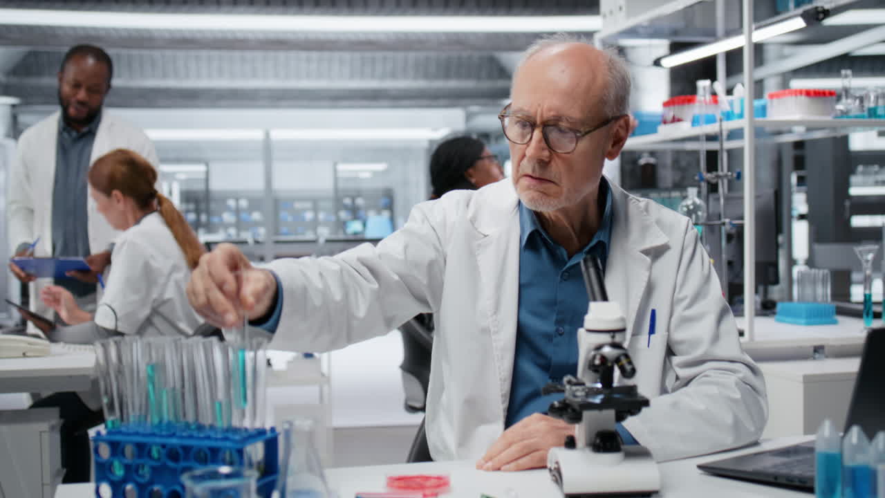 Upbeat elderly lab professional investigating blue liquid polymer properties