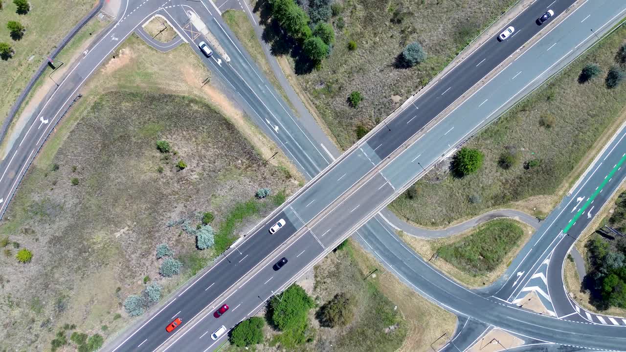 Drone aerial landscape car vehicles traffic driving on lanes freeway road overpass bridge in countryside rural town in Canberra ACT Australia transport travel infrastructure outdoors