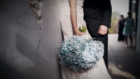 beautiful bride holding a beautiful bouquet of blue flowers