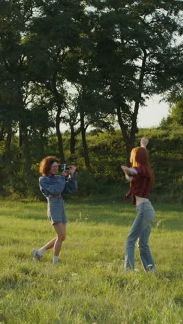 two women posing for photos in a field