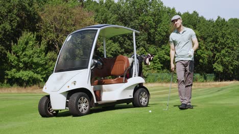 man playing golf with golf cart