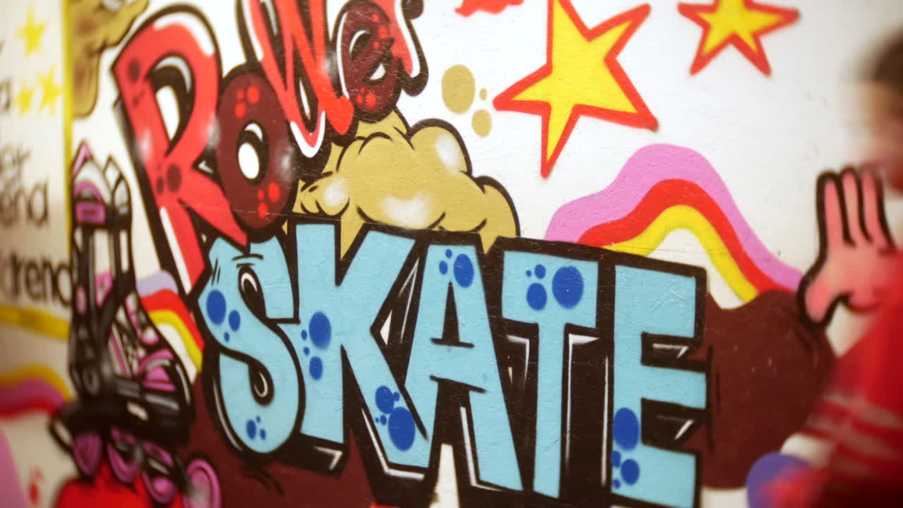 Girl skating past a roller skate graffiti sign at a rollerskating rink