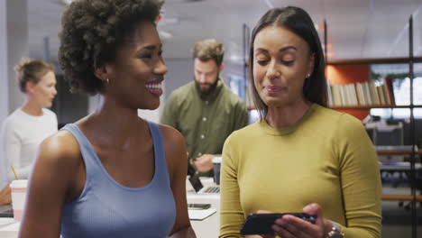 Portrait-of-happy-diverse-female-business-colleagues-talking-and-smiling