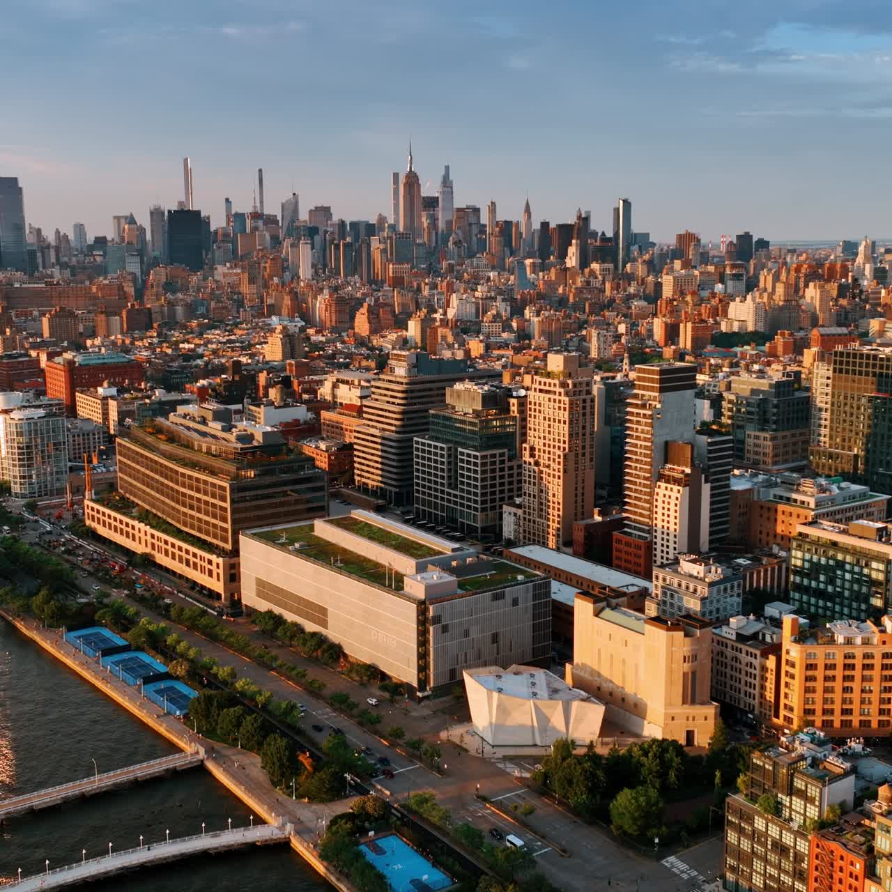 Bright cityscape of amazing New York at sunset. Drone footage above the Hudson River