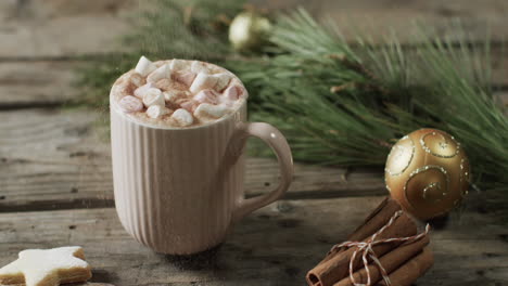 video of mug of christmas chocolate with marshmallows and copy space on wooden background