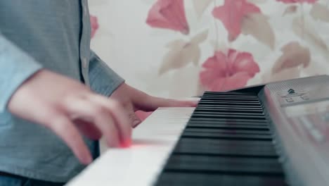 little boy playing on a musical synthesizer 1