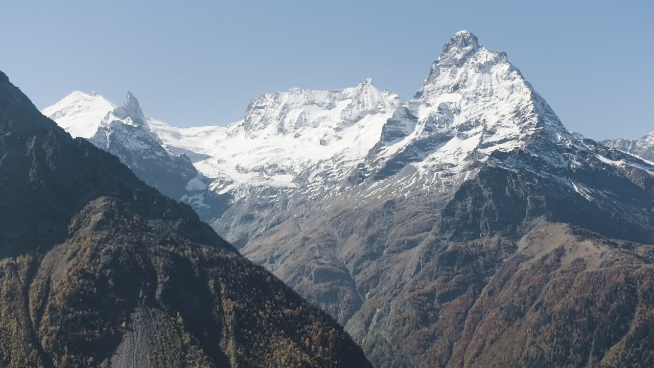 Snowy Mountain Peaks in Autumnal Landscape