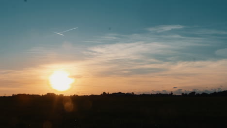 time lapse of a beautiful sunset with some clouds and airplanes crossing the sky