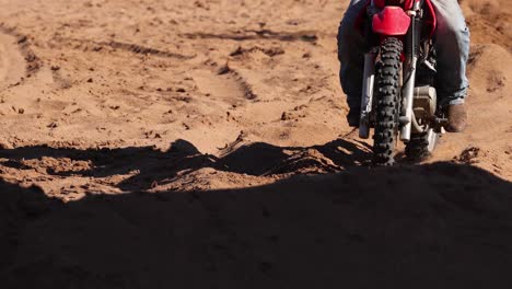 dirt bike rider tackling challenging sandy track