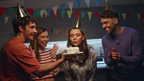 woman amazed birthday cake celebrating anniversary with happy friends close up.
