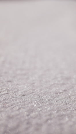 motion above soft clean white fabric at bright light extreme close view. textile sewing material texture. texture of smooth flat cloth surface