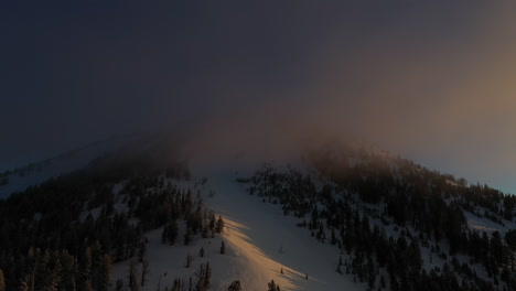 aerial view of dark clouds and sunny hillside on cold winter morning, hayden pass, colorado usa