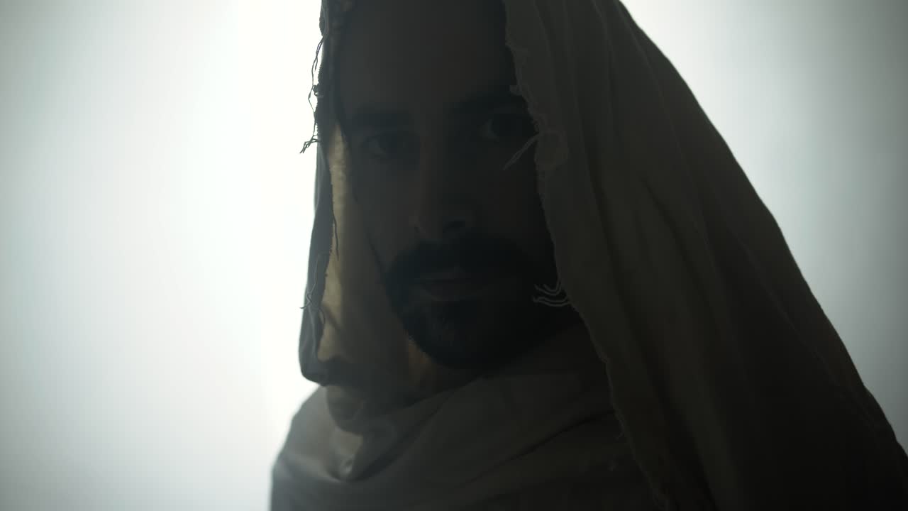 Jesus Christ resurrected on Easter Sunday inside empty tomb in bright, shining light, wearing white robes. Cinematic Christian, bible visual.