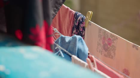 Drying-colorful-clothes-on-window-laundry-line-with-clothespins,-Cairo