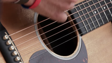 A-Man-Playing-the-Guitar-by-Strumming-It---Slow-Motion