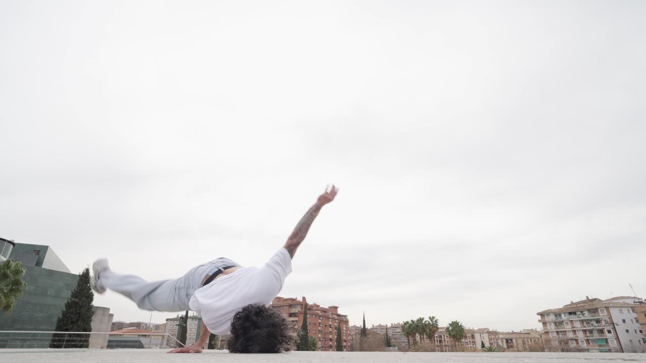 Breakdancer performing acrobatics on rooftop