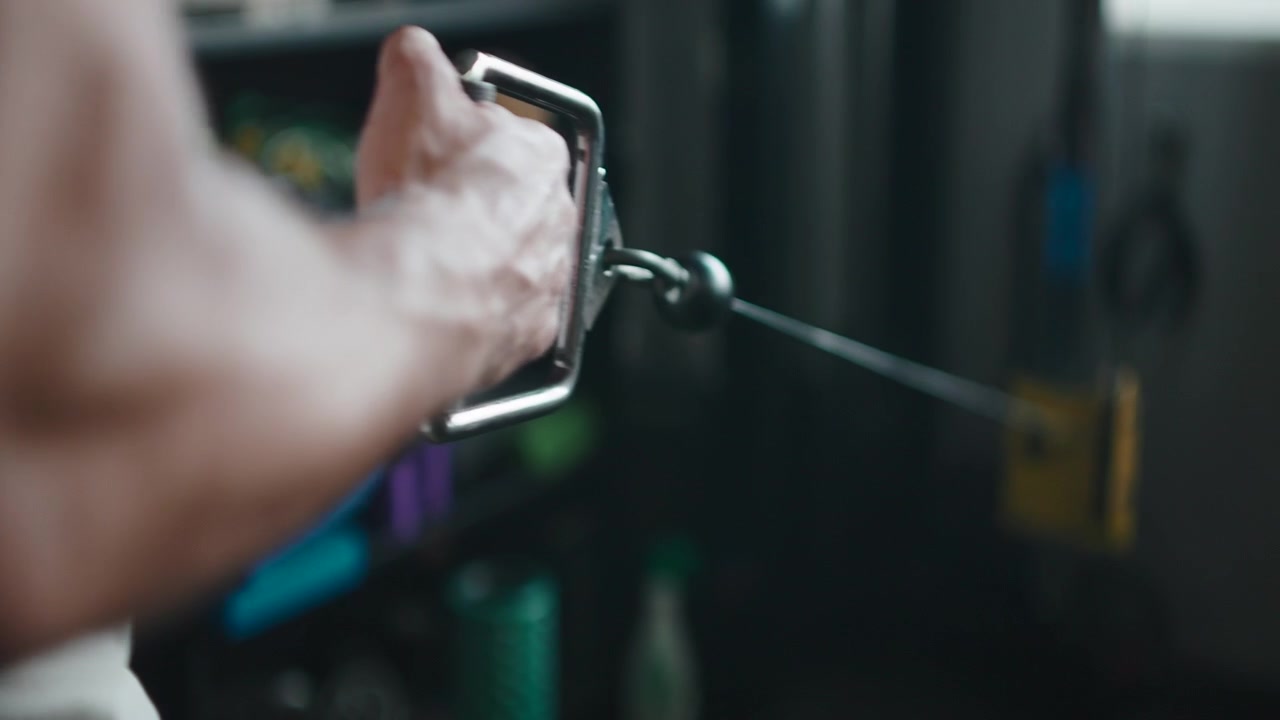 Muscular Man Performing Cable Row Exercise in Gym
