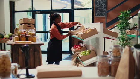 Storekeeper-arranging-crates-of-fruits-and-veggies