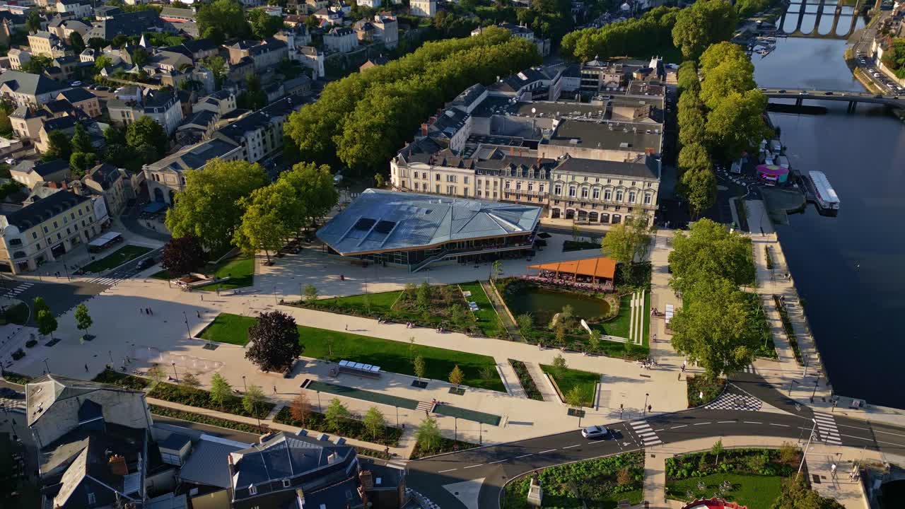 Nouvelle Place du 11 Novembre, new square in Laval, Mayenne river at sunset. Aerial drone backward