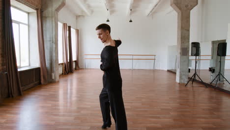 a male dancer performing in a bright studio