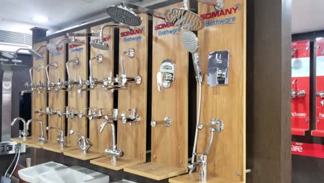 faucets in the store. large selection of faucets. plumbing showroom. bathroom interior. modern bathroom fixtures and accessories display in showroom.