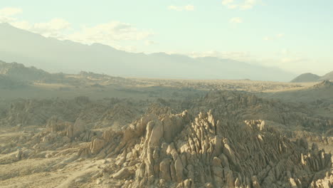 Flight-over-smokey-camp-sites-and-rock-formations-of-The-Alabama-Hills-in-California