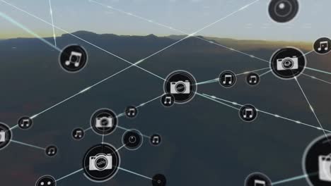 animación de iconos conectados con líneas sobre silueta de montañas contra el cielo