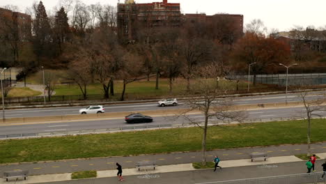 an-aerial-drone-time-lapse-on-a-gray-cloudy-day-as-the-drone-trucks-left-along-the-Shore-Parkway-bike-path