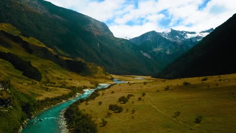 Waiatoto-river-stream-in-the-Mount-Aspiring-National-Park-Valley,-New-Zealand---aerial-ascending