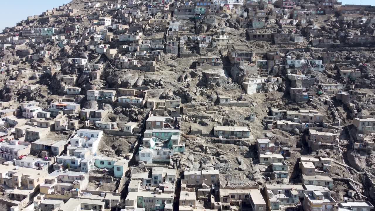 Aerial street scene of Kabul City Afghanistan, historic houses in the mountains, establishing drone flyover