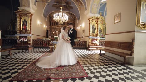 newlyweds. caucasian bride and groom together in an old church. wedding