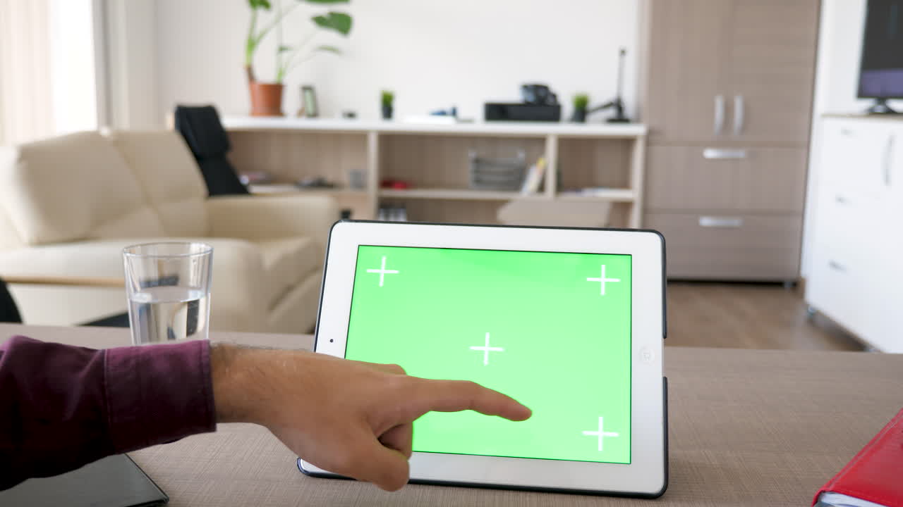 Tablet with Green Screen on Desk