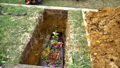 closeup shot of a funeral casket or coffin in a hearse or chapel or burial at cemetery