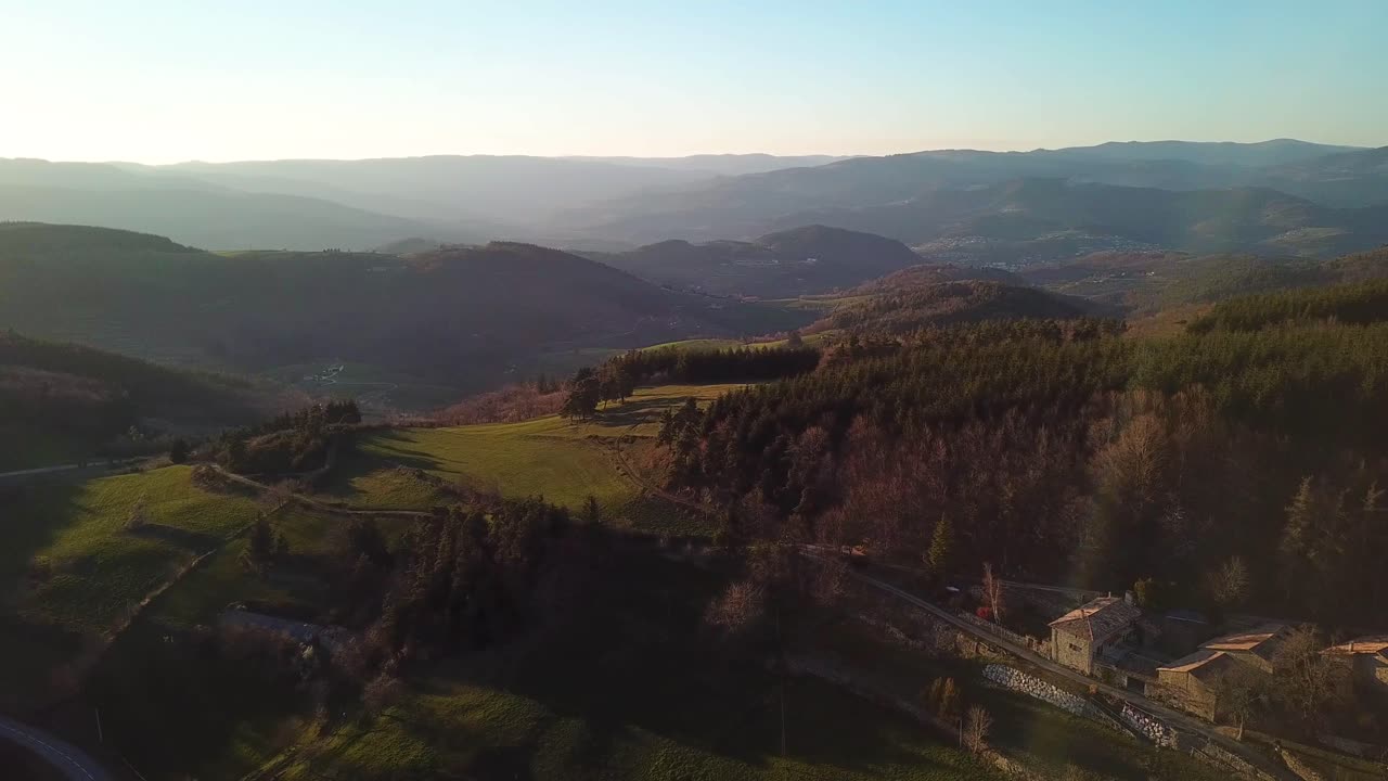 Drone View Of French Countryside With Forest, Hills And Village In Ard&egrave;che under sunset