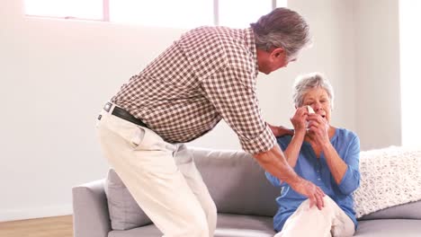 Mature-man-comforting-his-wife-crying-on-the-couch