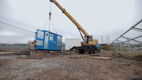 solar panel installation with crane and worker
