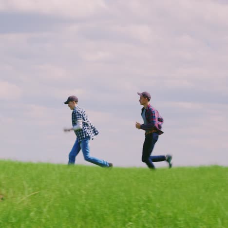 Two-Young-Teenage-Boys-Run-Along-The-Green-Hill-2
