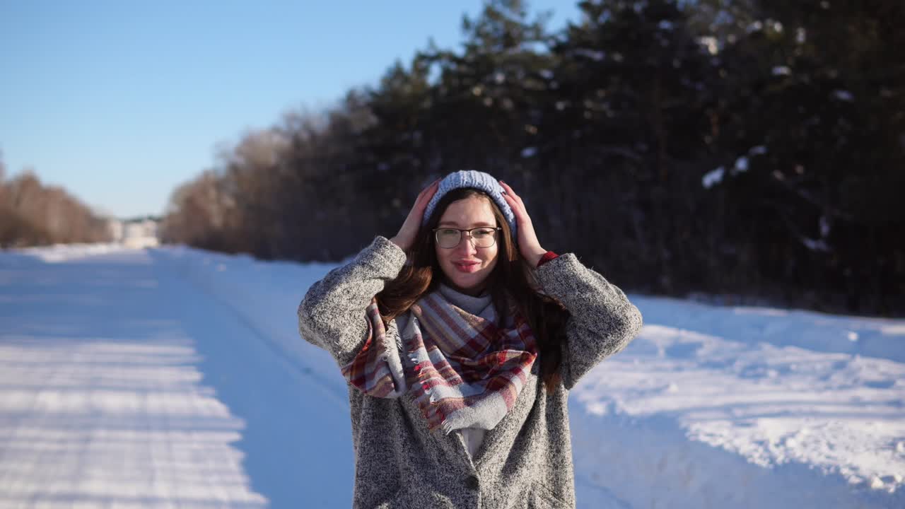 Woman in winter clothes in a snowy landscape