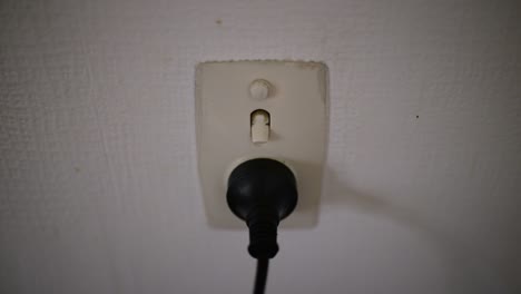 plugging in black plug then switching on power point