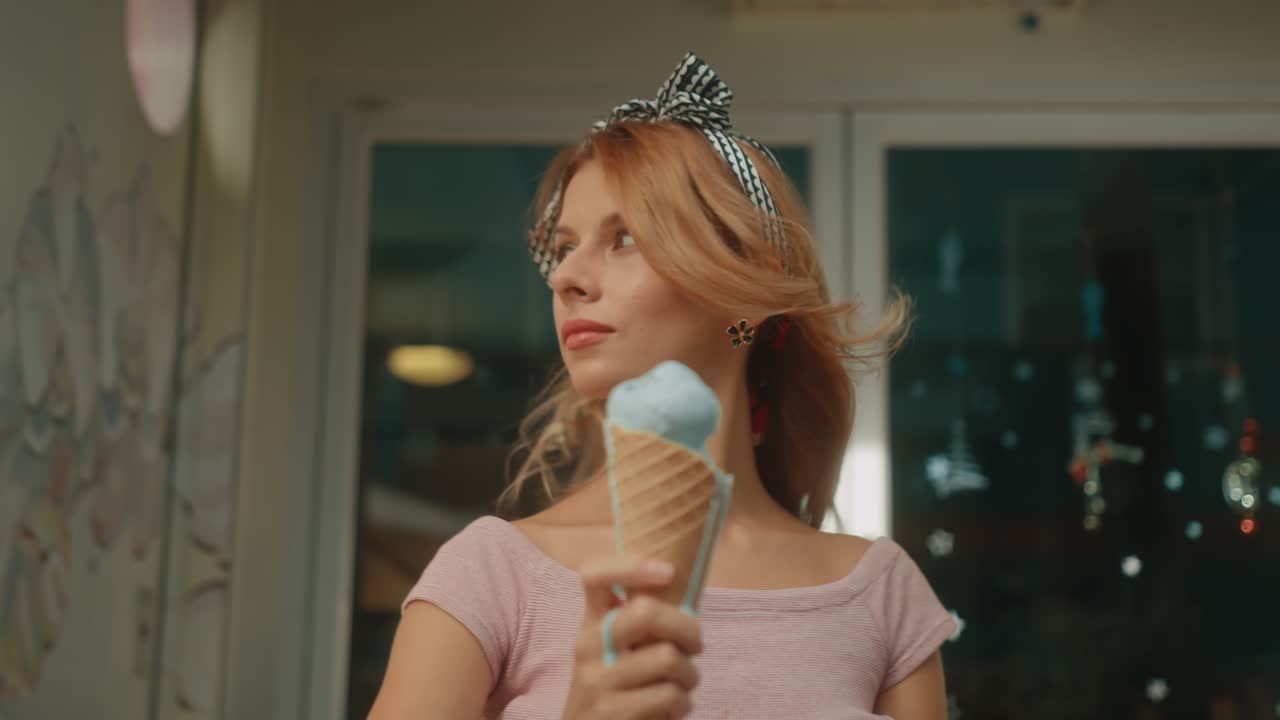 Woman Enjoying a Blue Ice Cream Cone