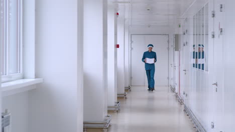 man in uniform carry white paper in corridor. male worker with pile of paper