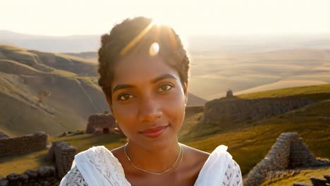 a woman smiling in a sunset landscape