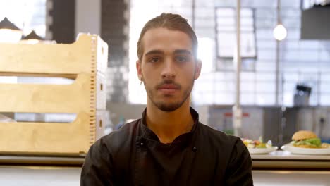 confident chef standing in commercial kitchen 4k