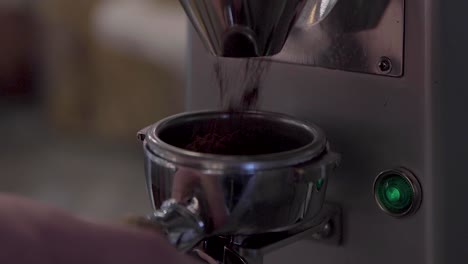 filling portafilter with freshly ground coffee, close up