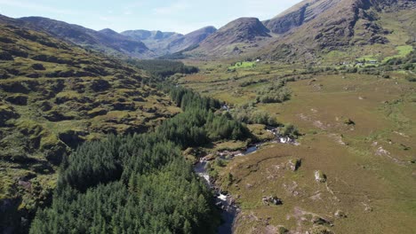 drone video of the black valley in kerry ireland showing a river, forest and mountains