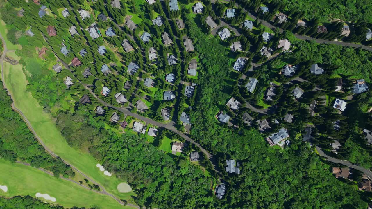 A forward top view of The Woodlands Tagaytay Highlands showing pine trees, hillside homes, and winding roads in Batangas, Philippines