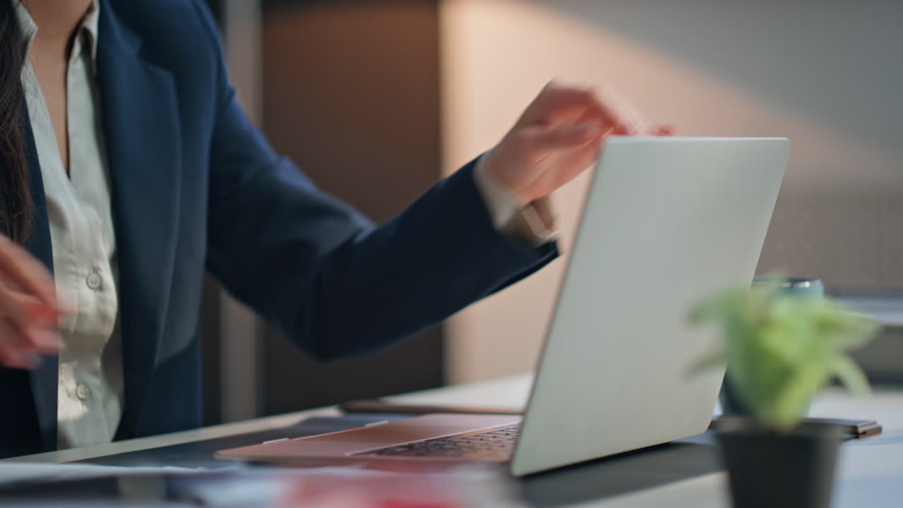 Supervisor hands holding documents texting laptop keyboard at workplace closeup