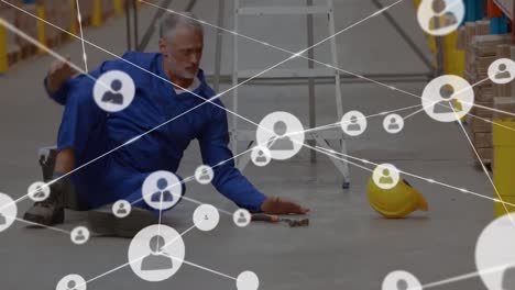 Animation-of-network-of-connections-over-man-falling-while-working-in-warehouse