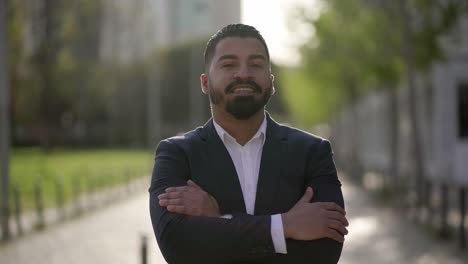 handsome happy businessman smiling at camera